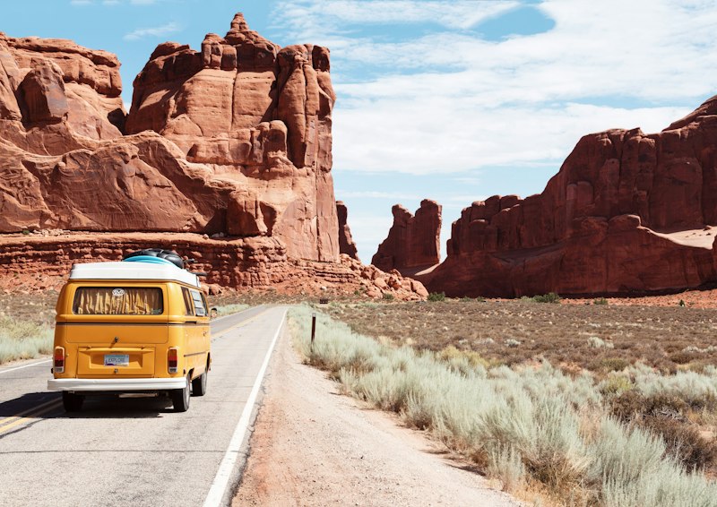 Vintage van driving on a scenic shared trip road adventure